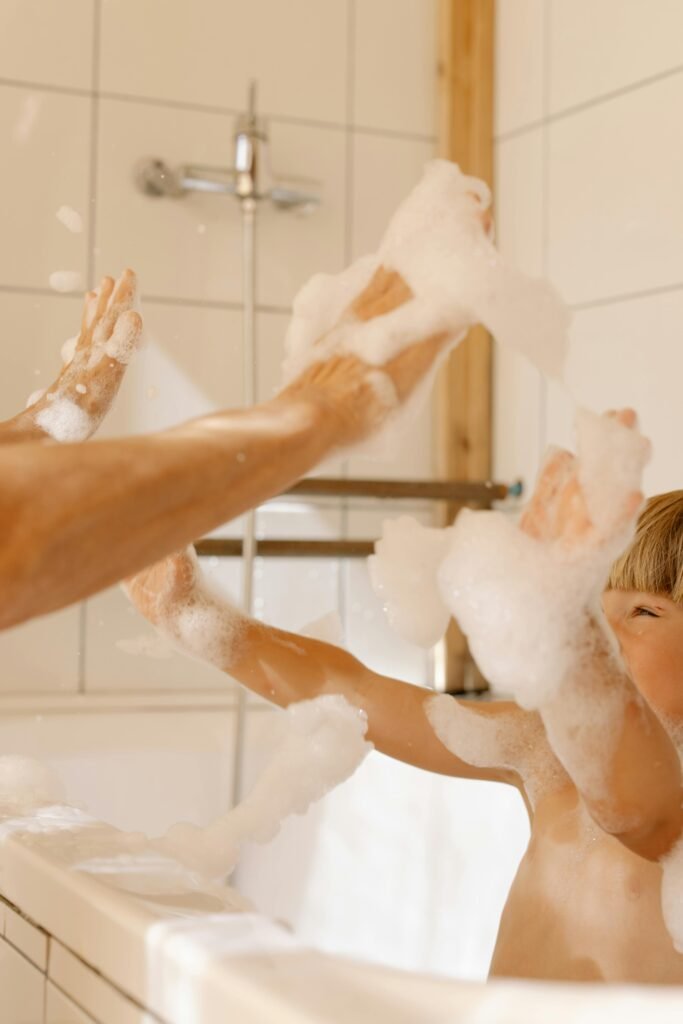A joyful child playing with foam in a modern bathroom, capturing a moment of fun and hygiene.